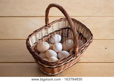 Quality chicken eggs from domestic breeding in a wicker basket