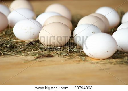 High quality tasty and healthy chicken eggs from domestic hens on wooden mat