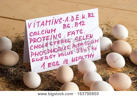 High quality tasty and healthy chicken eggs from domestic hens on wooden mat