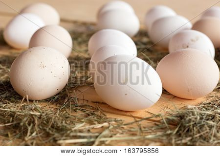 High quality tasty and healthy chicken eggs from domestic hens on wooden mat