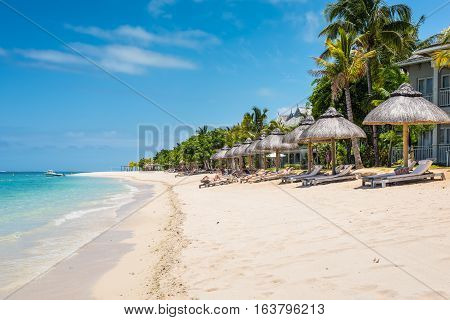 Le Morne Mauritius - December 7 2015: People relax on the Le Morne Beach Brabant one of the finest beaches in Mauritius and the site of many hotels and tourism facilities.