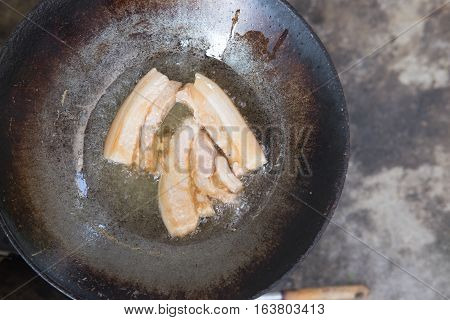 fried pork cooking in stainless still pan