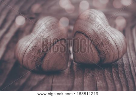 Background in sepia with two hearts of wood for valentins day