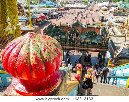 KUALA LUMPUR, MALAYSIA - JANUARY 13, 2014: Pilgrims and visitors go down on a huge ladder from Batu Caves. Kuala Lumpur, Malaysia