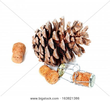Big pine cone and champagne wine corks with muselet. Isolated on white background.