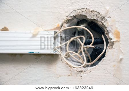 Exposed wire in the electrical wiring in the wall