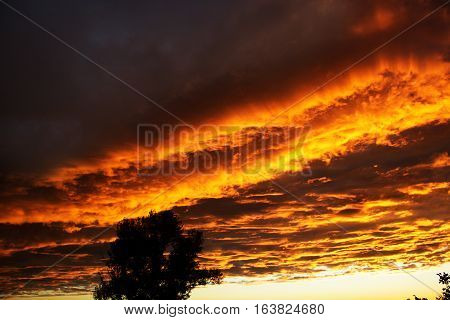 Dramatic sunset like fire in the sky with golden clouds