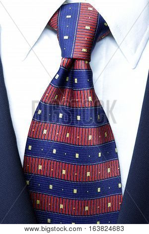 official dress code - classic blue suit, red tie knot, white shirt, closeup, official wear detail,