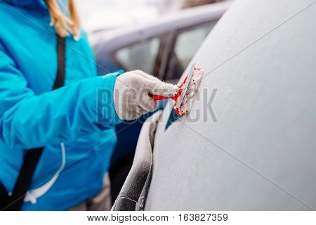 Woman Deicing Rear Car Windshield