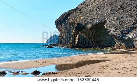 Volcanic rock-formations and crystal clear water at Playa de Monsul. Famous beach in the Cabo de Gata-Nijar Natural Park. Province of Almeria. Spain