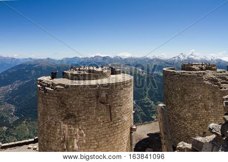 Ruined italian artillery turret on top of Mont Chaberton with Alps panorama.