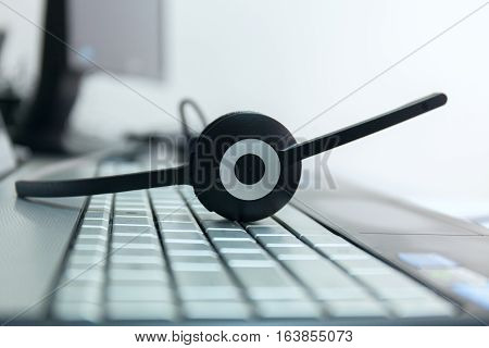 computer headphones on a keyboard of the notebook stock photo