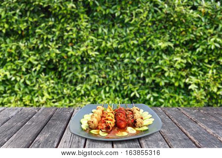 meatball in plate on woodtable and leaf background