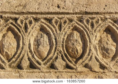 Bas-relief. stone architectural frieze with geometric patterns: abstract ornament.  Italy (Apulia).Detail of an architectural frieze of a drywall.