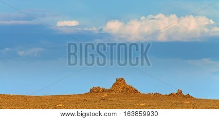 Nevada landscape at sunset near Lovelock NV. Tufa rock formations under blue sky.