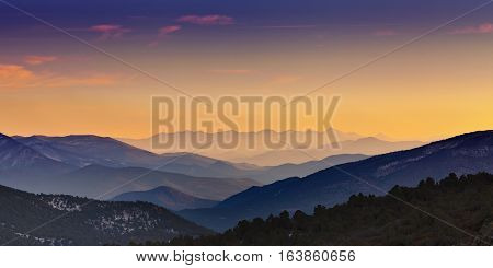 Mountain ranges at sunset receding in layers into the distance. View is from Rowe Peak near Dayton Nevada