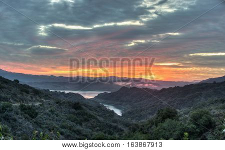 Lake Casitas glowing under sunrise cirrocumulus clouds.