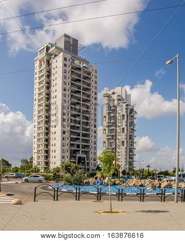 Rishon LeZion, Israel-May 28, 2016: Two modern multi-story apartment residential buildings located at Golda Meir Street in Kiryat Rishon district. Vertical shot in bright sunny day on blue sky background
