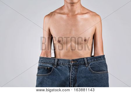 A Man In Bigger Jeans With Thin Body, Asian Man In Studio Photography.