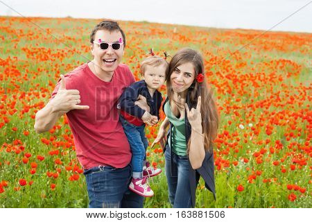 Field of flowers. Happy family having rest on the nature
