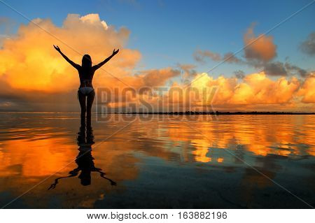 Silhouetted Woman Standing In A Water At Sunset On Taveuni Island, Fij
