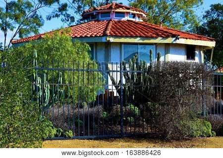 Spanish style Hacienda Villa with drought tolerant landscaping including chaparral shrubs and cacti