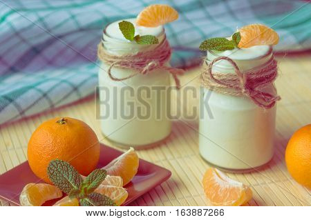 Fresh Organig Natural White Yogurt In Glass Jars With Tangerine And Mint