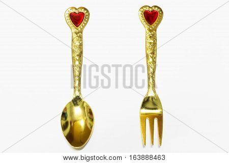 the gold Spoon and fork on a white background.