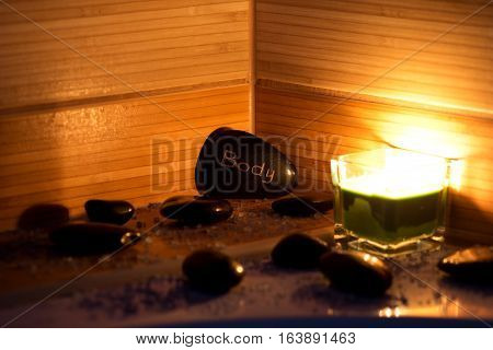 black lava stones massage green candle and bath salt