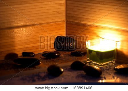 black lava stones massage green candle and bath salt