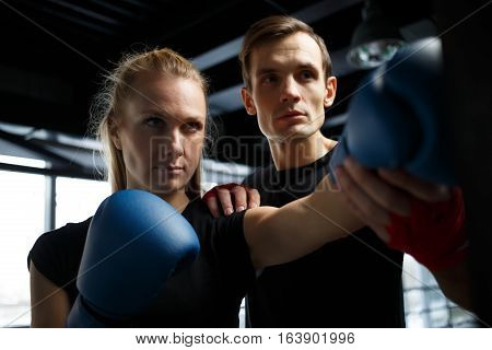 Young athletes training in boxing in hall