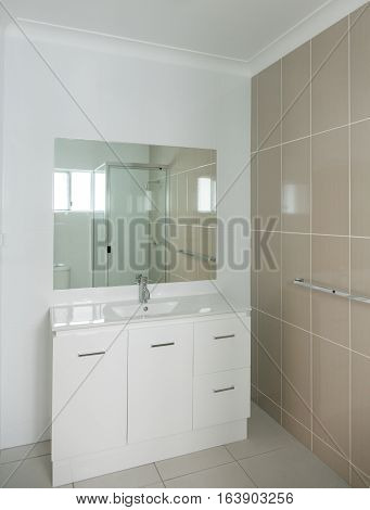 New compact ensuite bathroom with vanity and tiled walls