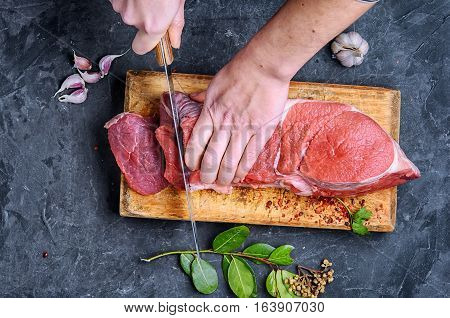 Woman In The Kitchen Is Cutting Beef