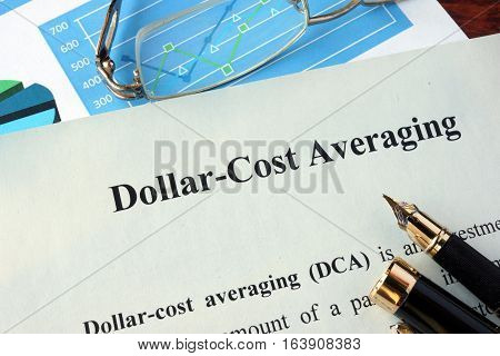 Dollar-cost averaging (DCA) on a paper and charts.