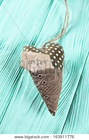 heart with an inscription on a wooden background