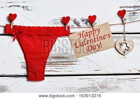 Red panties on rope. Valentine's Day card and lingerie. Sexy gift for girlfriend.