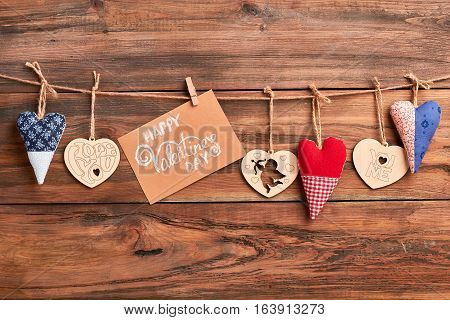 Hearts and card on rope. Colorful hearts and greeting paper. Make surprise on Valentine's Day.