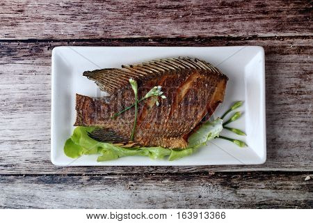 Deep Fried Little Tilapia Fish Served With Spicy Bean Sauce.