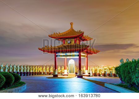 View of temple with buddhas at night