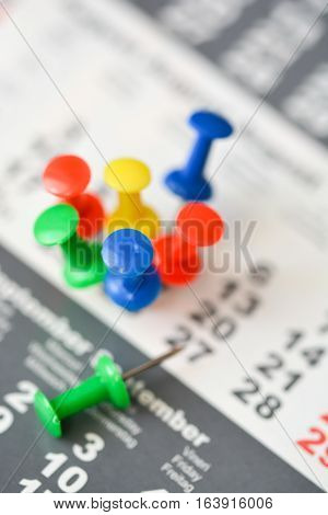Multiple pins on a calendar suggesting busy day or schedule