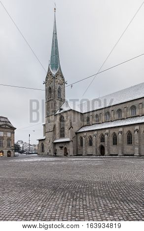Zurich, Switzerland - 3 January, 2017: Munsterhof square and Fraumunster cathedral in the historical part of the city on an overcast day in winter. Zurich is the largest city in Switzerland and the capital of the Swiss canton of Zurich.