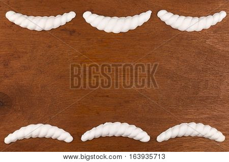 Luxury frame made of white stucco plaster lying on a dark wood with a place for your text