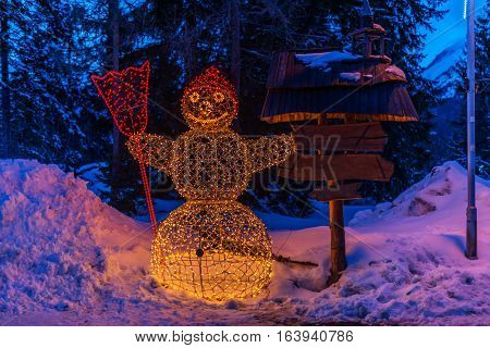 Winter in High Tatras Mountains. High Tatry. Slovakia. Vysoke Tatry. Christmas and New Year decoration.  Illuminated Snowman
