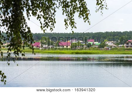 River Karakan the village of Zavyalovo Novosibirsk oblast Siberia Russia - July 7 2016: a view of the ancient Siberian village across the river