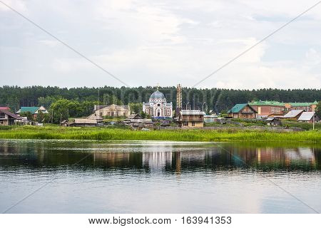 River Karakan the village of Zavyalovo Novosibirsk oblast Siberia Russia - July 7 2016: a view of the ancient Siberian village across the river