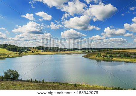 Russian summer landscape. Village Chusovoe. A view to the river Shaytanka at the confluence of the river Chusovaya with the top of the hill