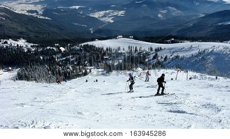 Skiers on snowy the view from the top a beautiful landscape of the ski resort