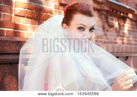 beautiful bride in veil close up outside
