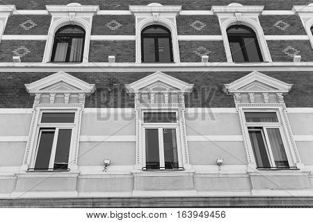 facade with windows in ancient style. vertical shot