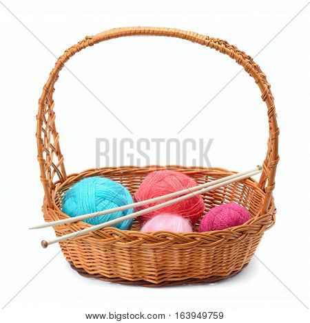 skeins of yarn and knitting needles isolated on a white background